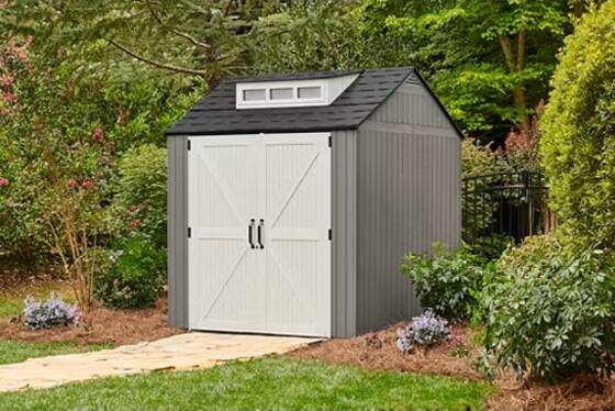 Rubbermaid 7x7 gray resin shed assembled in a backyard setting.