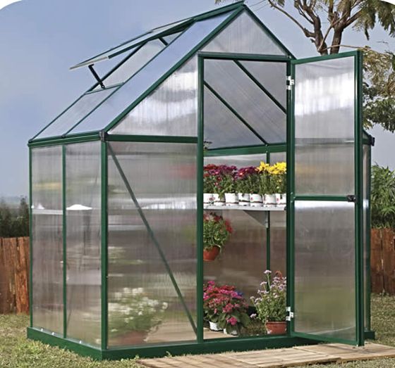 Elevate your outdoor space with a sleek greenhouse featuring virtually unbreakable polycarbonate panels.