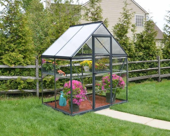 Elevate your outdoor space with a sleek greenhouse featuring virtually unbreakable polycarbonate panels.