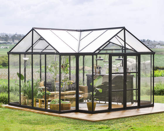 Triomphe Garden Chalet with clear glazing and durable aluminum frame.