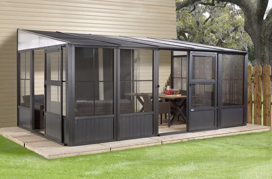 Sojag Charleston Solarium Kit assembled on the side of the house to create a stylish, enclosed outdoor space